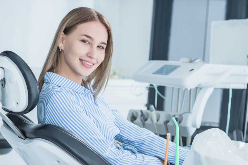 woman smiling sitting in a dentist chair